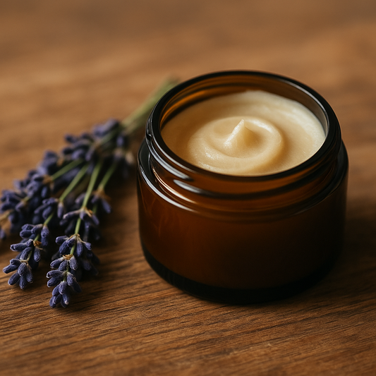 A high-resolution photograph features an open amber glass jar filled with a creamy, yellow-toned balm. The jar is set on a soft neutral surface, surrounded by dried lavender sprigs and a wooden scoop, evoking a calm and soothing nighttime atmosphere.