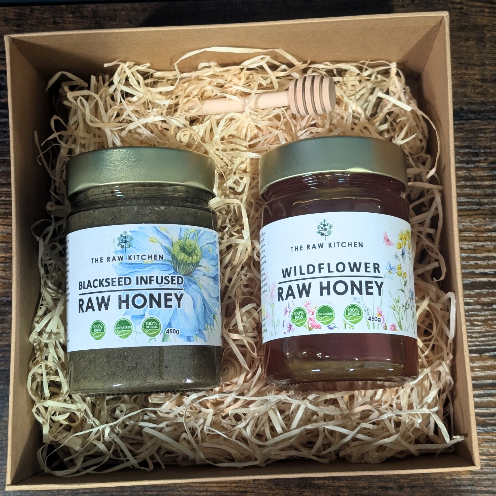 A Raw Honey Gift Box from The Raw Kitchen UK, featuring a combination of Blackseed Infused and Wildflower raw honeys.