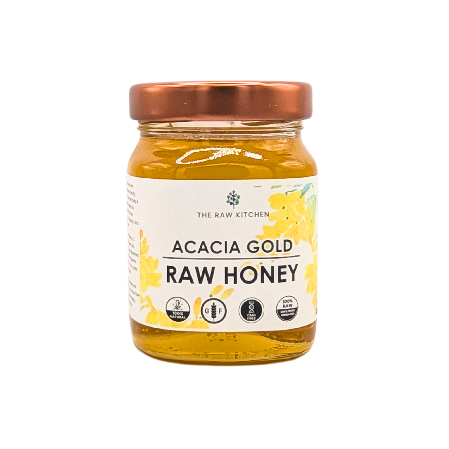 A 450g glass jar of Acacia Raw Honey with a gold lid and branded label - The Raw Kitchen UK.
