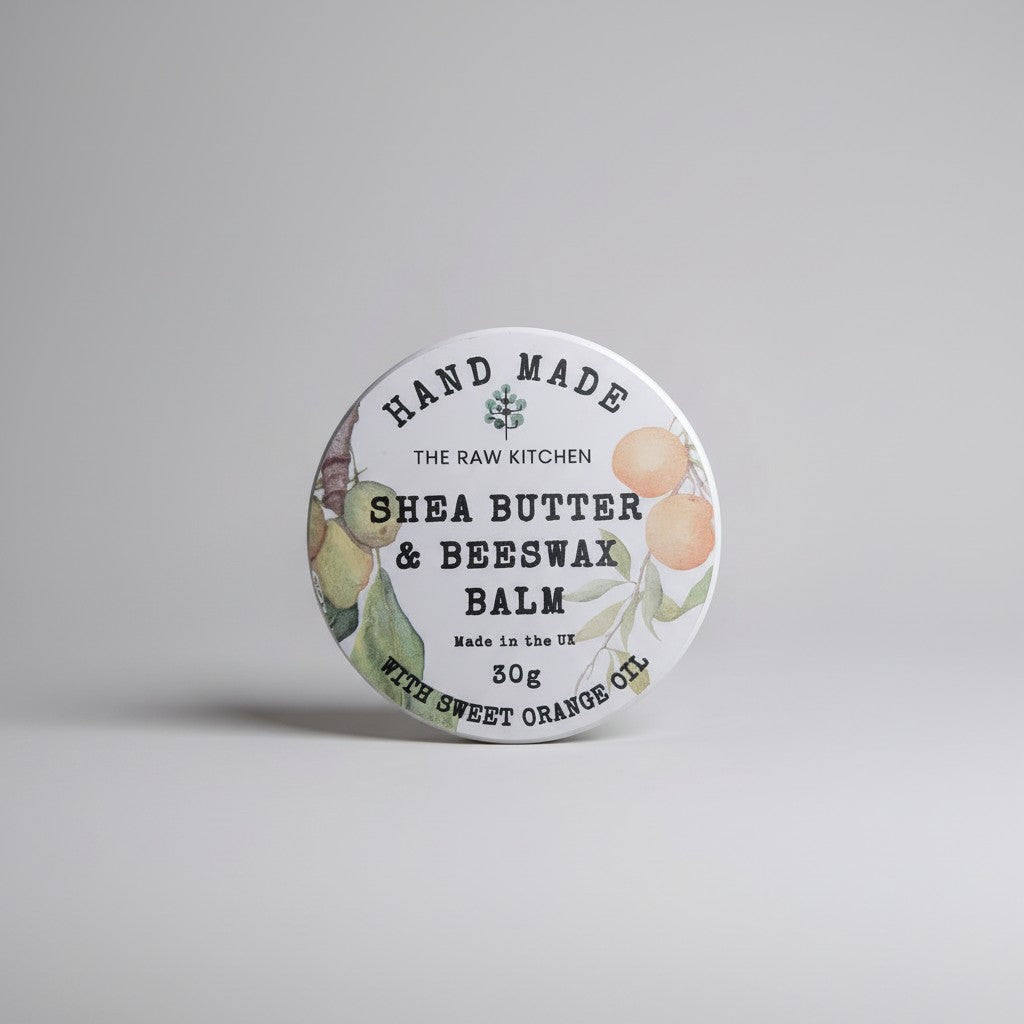 Shea butter and beeswax balm container with branding on a gray background