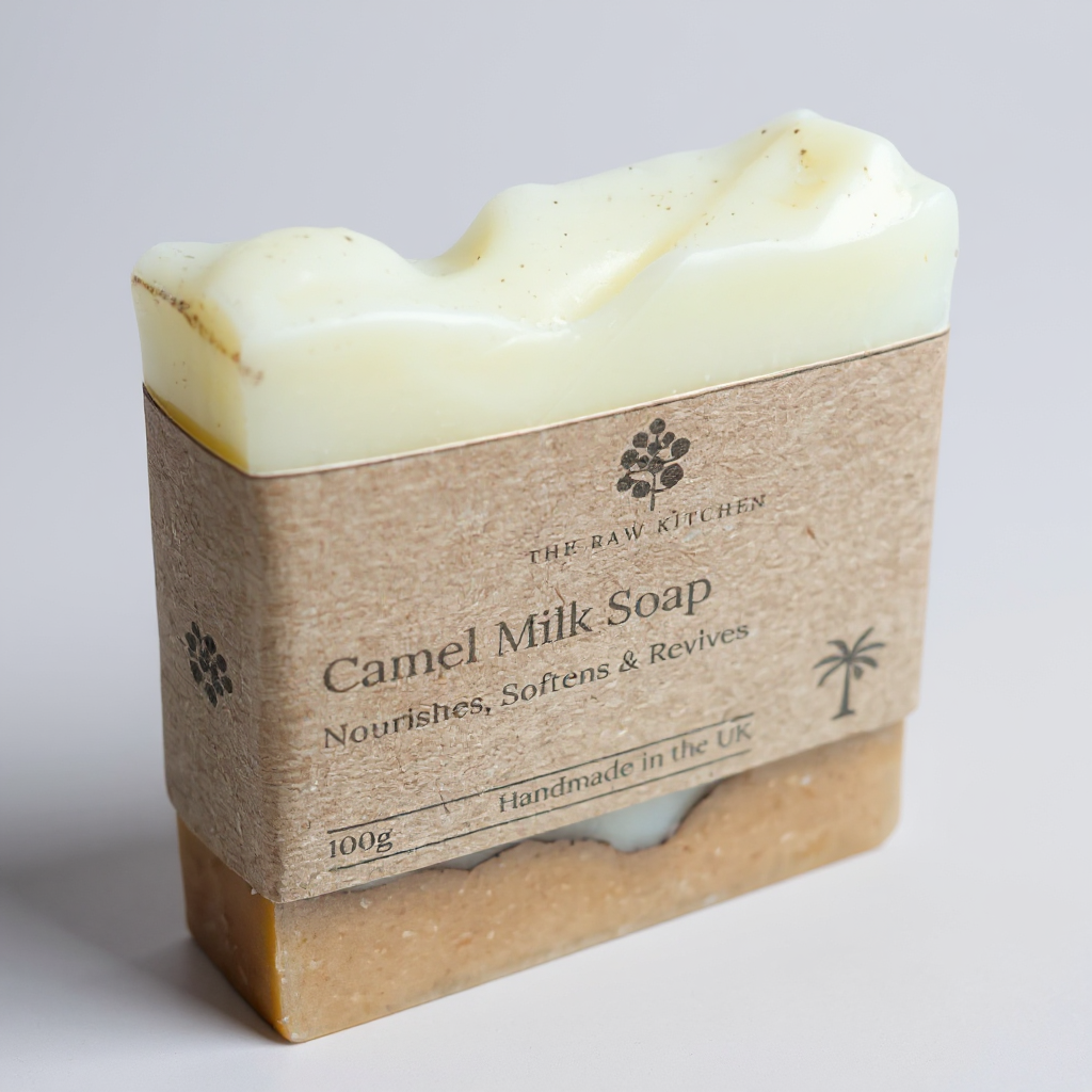 Bar of camel milk soap with a brown paper wrap on a light gray background