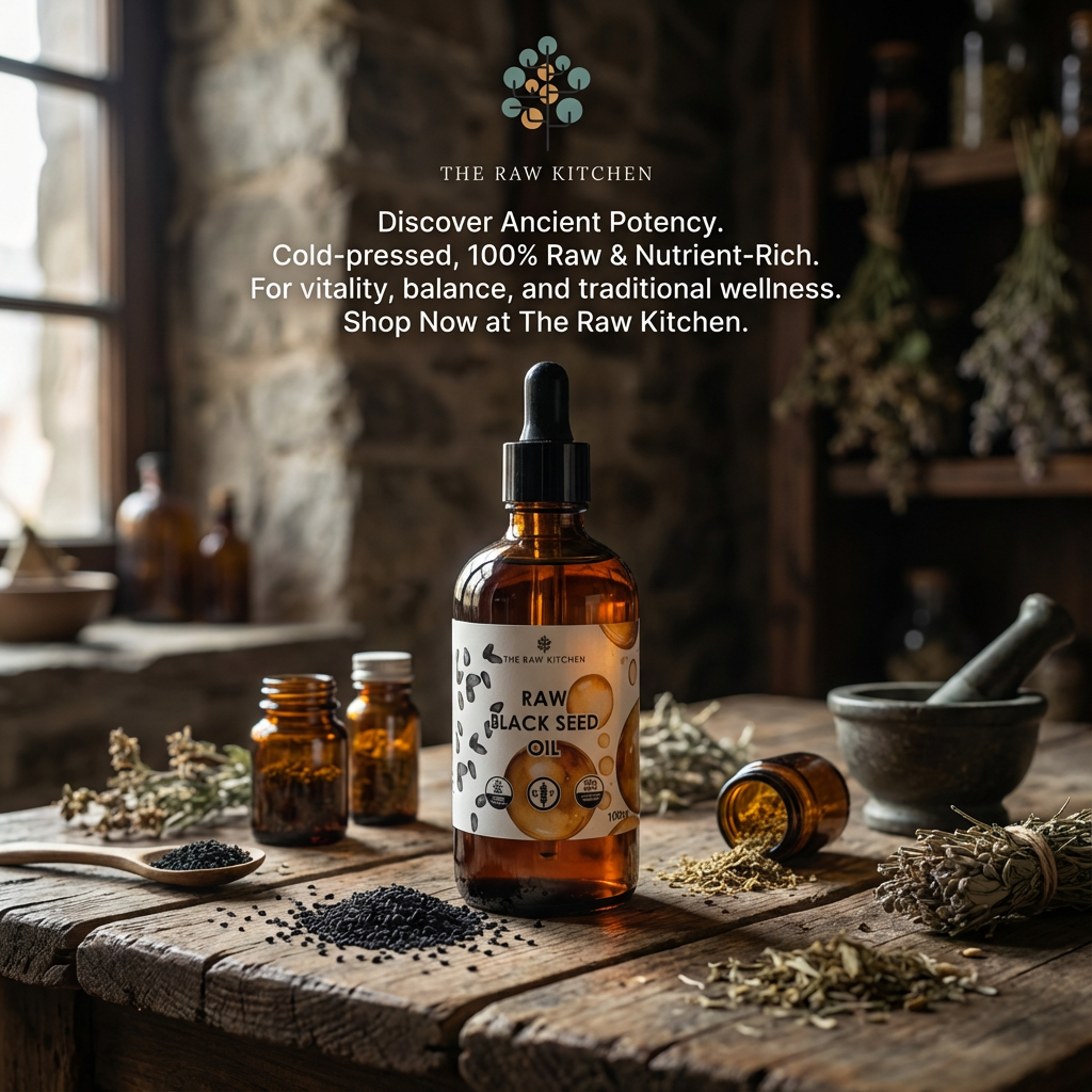Bottle of Raw Black Seed Oil on a wooden table with herbs and a rustic background, featuring The Raw Kitchen branding.